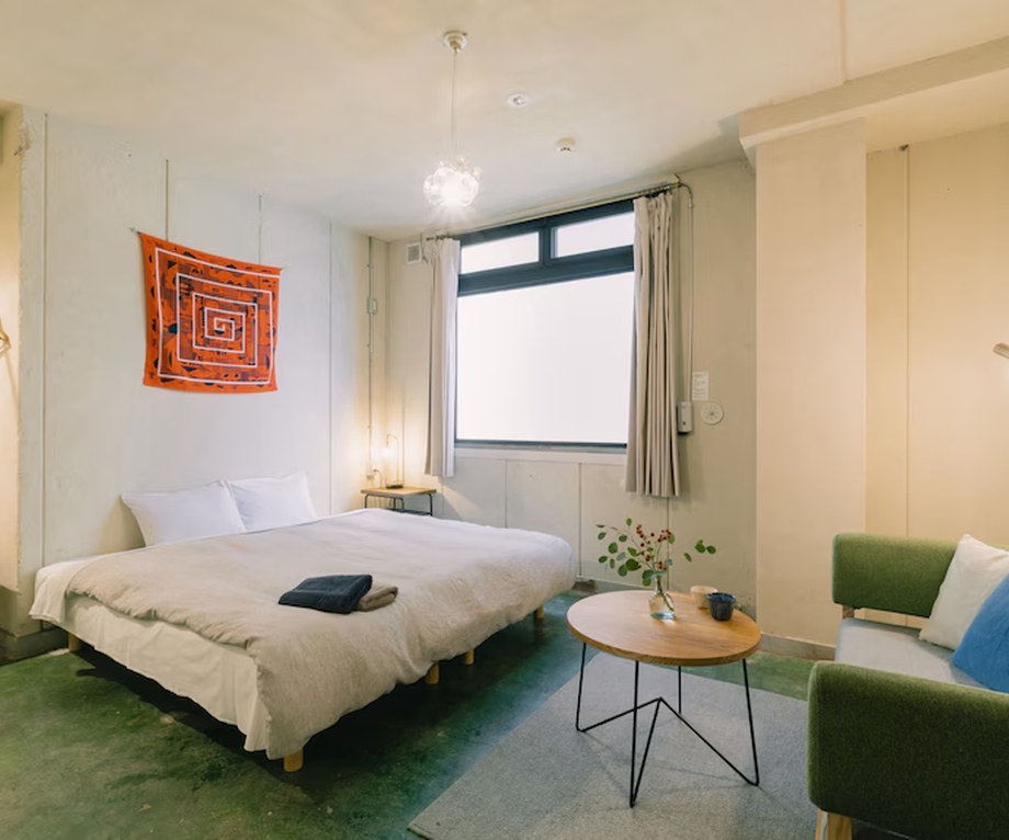 Kyoto sleeping module closed by a fabric curtain along a dim shared corridor